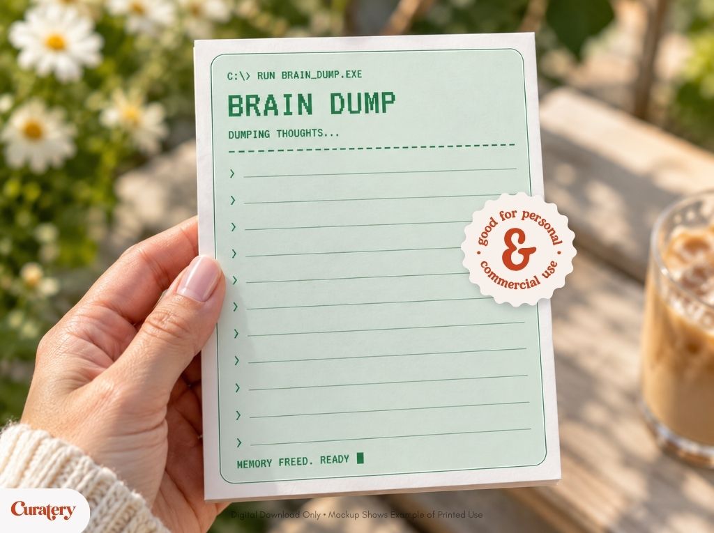 A hand holds a light green notepad designed like a computer command prompt, displaying "BRAIN DUMP", "DUMPING THOUGHTS...", and "MEMORY FREED. READY", with a sticker indicating "good for personal & commercial use".
