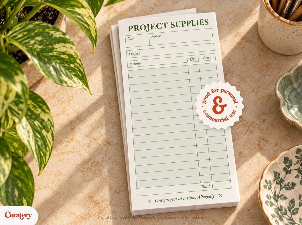A white notepad titled "PROJECT SUPPLIES" with fields for date, notes, project, supply, quantity, price, and total, is displayed on a textured surface next to a potted plant and ceramic dishes, featuring a circular sticker that reads "good for personal & commercial use" and the phrase "One project at a time. Allegedly." at the bottom.