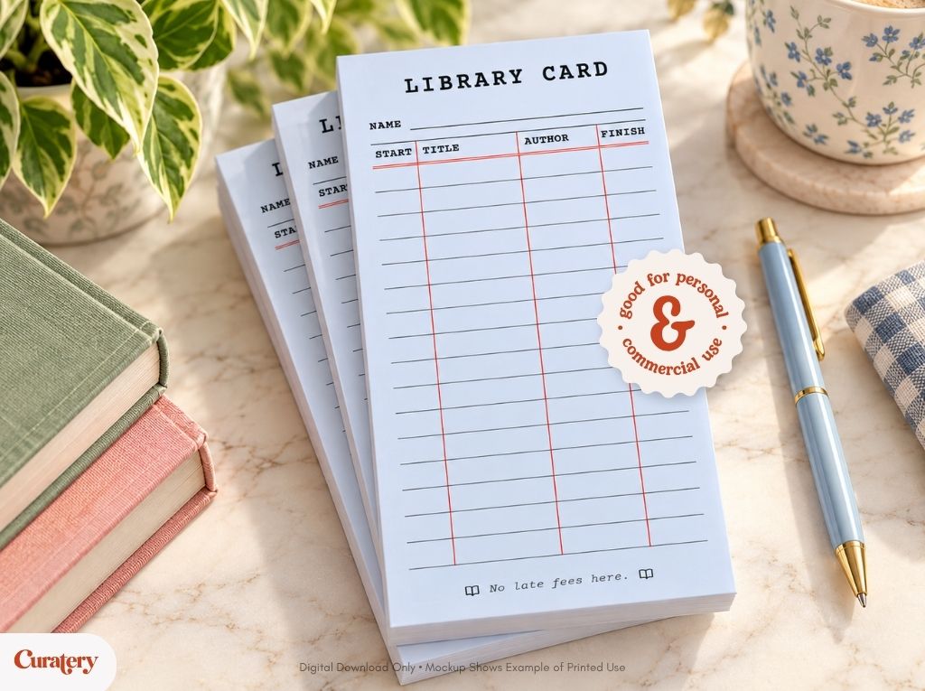 A stack of light blue notepads designed as library cards, featuring columns for "NAME," "START," "TITLE," "AUTHOR," "FINISH," and the phrase "No late fees here," is displayed on a marble surface next to books, a plant, a pen, and a mug.